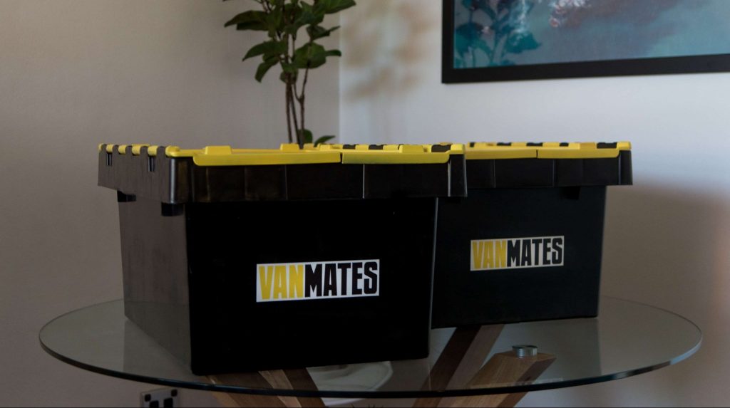 Two plastic moving boxes with Vanmates sticker